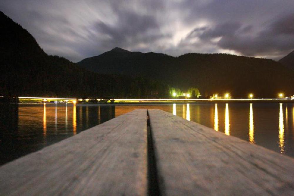 Lake in Davos at night (stream of light in the background is a train)